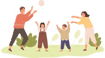 A family is playing with a ball outside. Dad is throwing the ball to mom right above their children's head